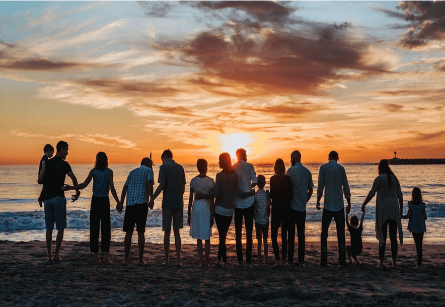 family bonding by the shore at beautiful sunset